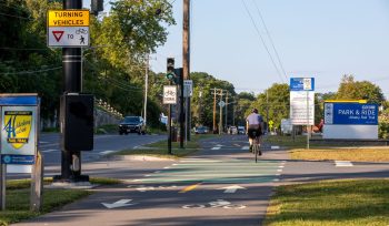 Image of a bicyclist on a cycle track at a CDTA park and ride lot on South Pearl Street in Albany