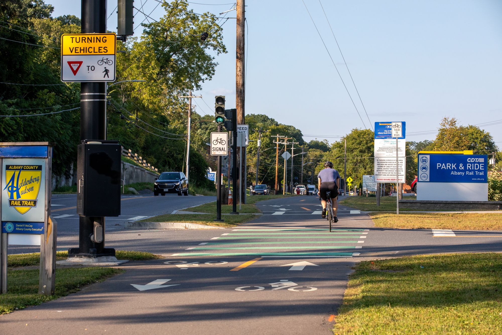 Image of a bicyclist on a cycle track at a CDTA park and ride lot on South Pearl Street in Albany